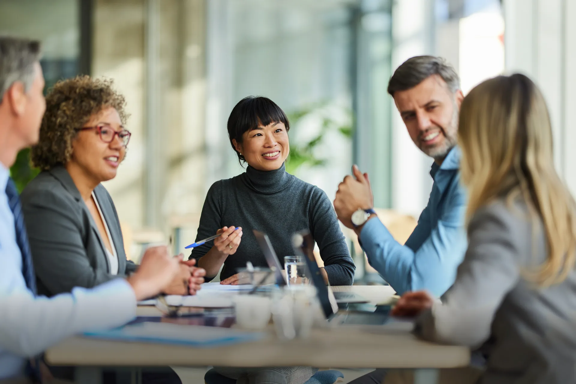 Business colleagues collaborating around a conference table with secure private data